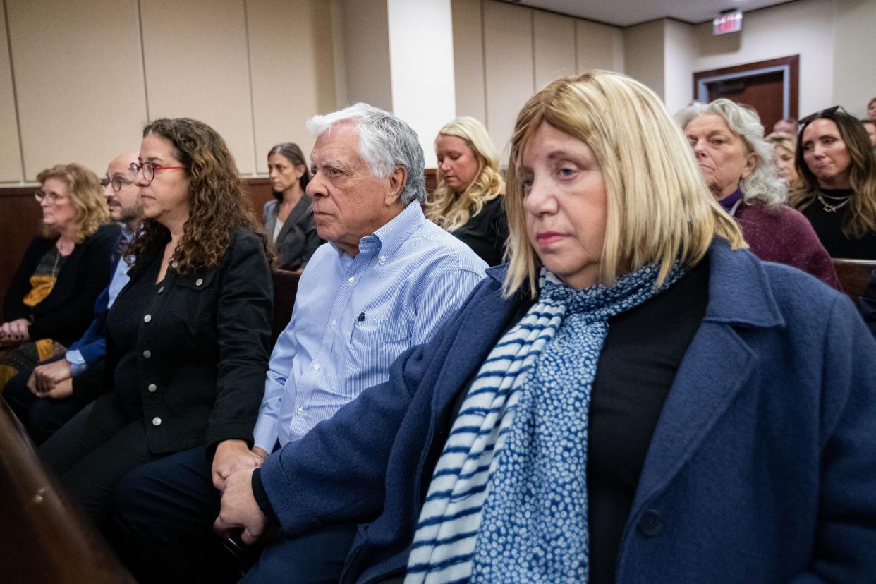 Shelly Markel, left, holds hands with her mother Ruth across Phil Markel’s lap as they wait for the verdict to be read in Charlie Adelson’s trial for the murder of Dan Markel on Monday, Nov. 6, 2023.