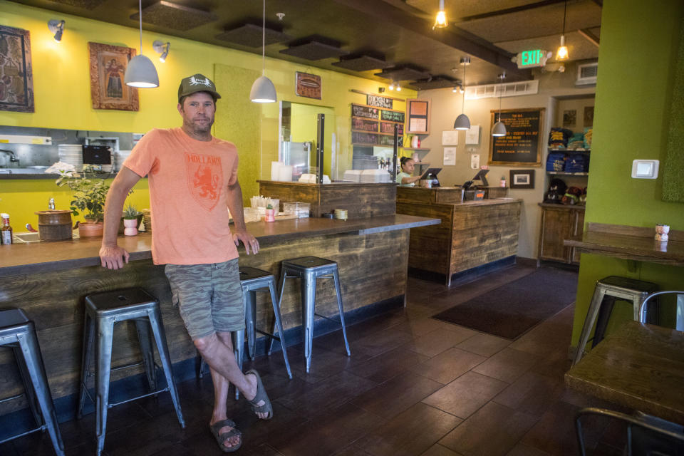 Pica's Mexican Taqueria co-owner Andy Parazette poses for a portrait inside of his business in Jackson, WY. on Aug. 23, 2023. At the height of the post-pandemic economic recovery, Parazette's shop saw such a crush of business that customers sometimes had to wait an hour for a burrito. This year, business is still good but has cooled, Parazette said, though other restaurants more dependent on tourism have experienced steeper drops. (AP Photo/Amber Baesler)