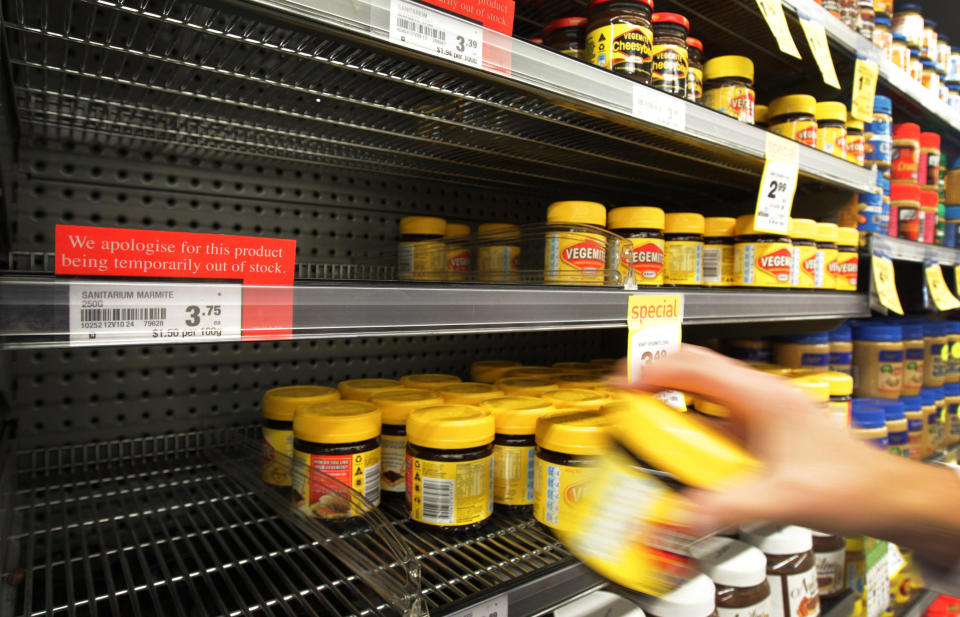 A customer takes a jar of Vegemite from next to an empty shelve where Marmite should be stocked in a supermarket in Auckland, New Zealand, Tuesday, March 20, 2012. The manufacturer, Sanitarium, announced this week it had run out of Marmite, the sticky black spread that fans adore and doubters think would be better used for axle grease. (AP Photo/New Zealand Herald, Sarah Ivey) NEW ZEALAND OUT, AUSTRALIA OUT