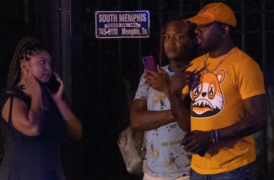 People stand on the other side of the street as Memphis police officers work the scene of a shooting MPD believes was committed by a man driving around shooting Wednesday, Sept. 7, 2022, on McLean Boulevard between  Madison and Poplar avenues. 