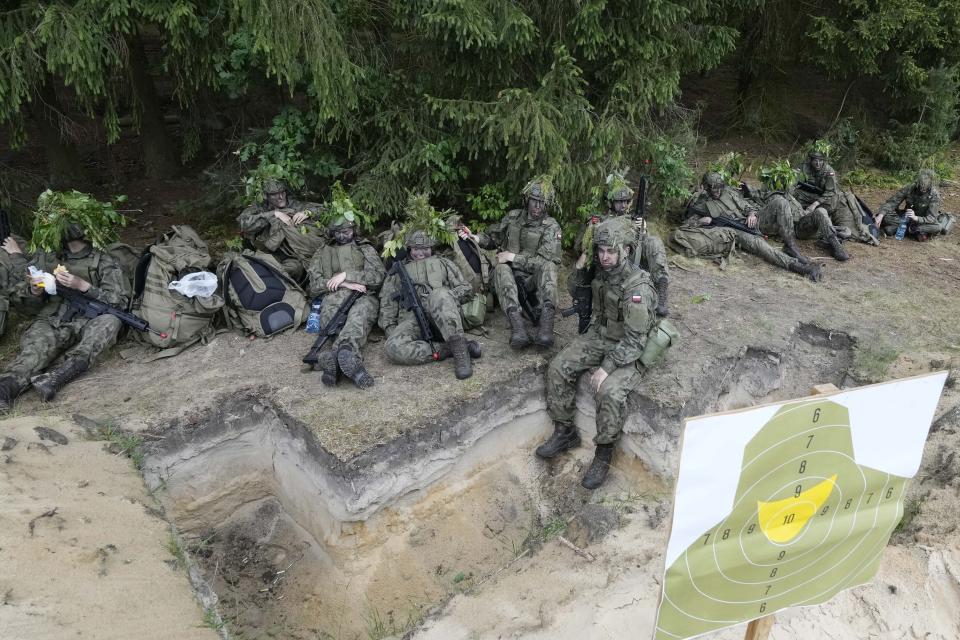 Volunteers in Poland's army take a break during training exercises in Nowogrod, Poland, on Thursday June 20, 2024. The volunteers are taking part in summer training program called "Holidays with the Army." Despite the name, it is basic military training in combat, shooting and other skills as Poland seeks for new recruits for its growing army, mindful of Russia's revived imperial ambitions. (AP Photo/Czarek Sokolowski)