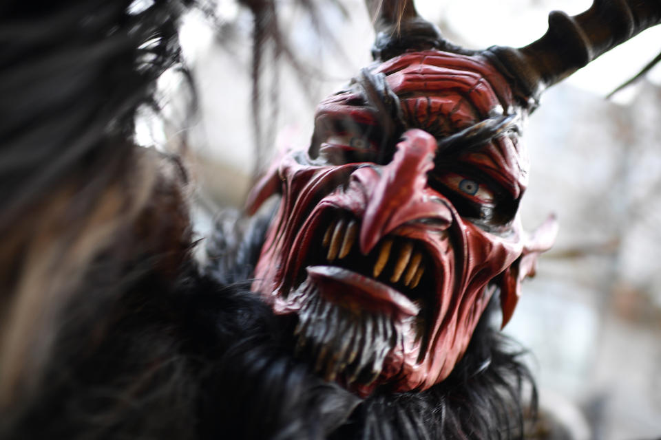 MUNICH, GERMANY - DECEMBER 09: An actor dressed as the Krampus creature parades through the city center's pedestrian shopping district on December 9, 2018 in Munich, Germany. Krampus traditionally accompanies Saint Nicholas and angels in a house to house procession to reward children who have been good and warn those who have not, though in recent decades Krampus parades have become an intrinsic part of local folklore and take place throughout the end of November and into the first half of December in the alpine regions of Germany, Austria and Italy. Krampus usually wears large cowbells on his back that he rings by shaking his hips to ward off the evil spirits of winter. He also carries a switch made of branches or animal hair that he uses to whip bystanders. (Photo by Sebastian Widmann/Getty Images)