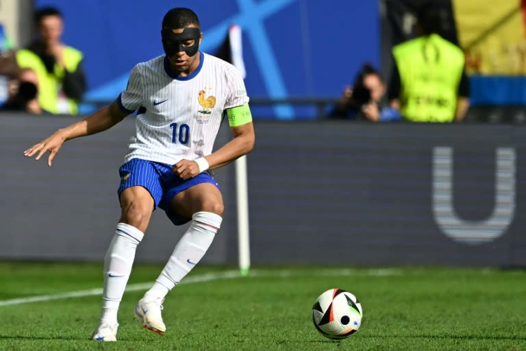 A masked <a class="link " href="https://sports.yahoo.com/soccer/players/3893765/" data-i13n="sec:content-canvas;subsec:anchor_text;elm:context_link" data-ylk="slk:Kylian Mbappe;sec:content-canvas;subsec:anchor_text;elm:context_link;itc:0">Kylian Mbappe</a> playing for <a class="link " href="https://sports.yahoo.com/soccer/teams/france/" data-i13n="sec:content-canvas;subsec:anchor_text;elm:context_link" data-ylk="slk:France;sec:content-canvas;subsec:anchor_text;elm:context_link;itc:0">France</a> against <a class="link " href="https://sports.yahoo.com/soccer/teams/belgium/" data-i13n="sec:content-canvas;subsec:anchor_text;elm:context_link" data-ylk="slk:Belgium;sec:content-canvas;subsec:anchor_text;elm:context_link;itc:0">Belgium</a> in the last 16 at Euro 2024 (OZAN KOSE)