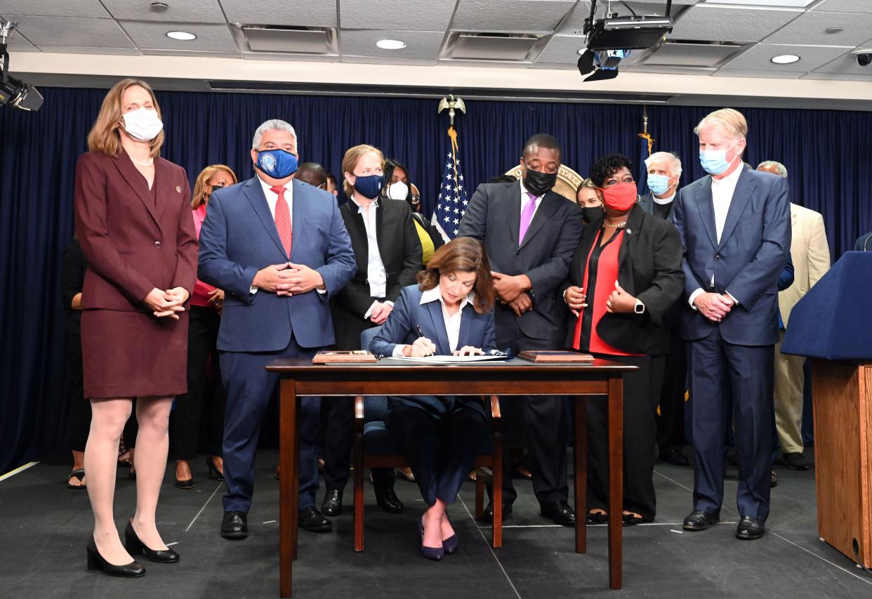 Flanked by Lieutenant Governor Brian Benjamin, progressive advocates and state Democratic leaders, New York Gov. Kathy Hochul signed "The Less Is More Act" in Manhattan, New York on Sept. 17, 2021.