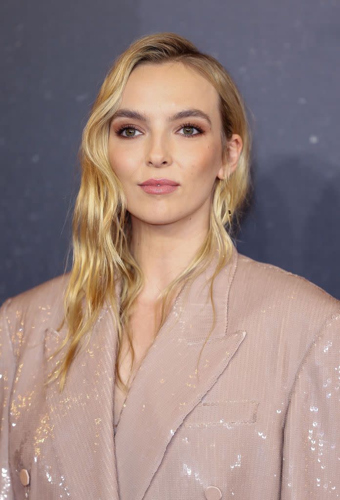 <p>Give beachy waves a French-girl twist by leaving them tucked into your blazer. </p>