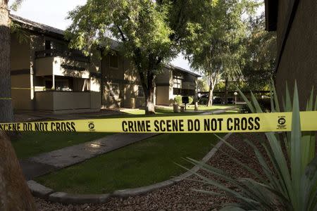 Crime scene tape surrounds buildings at the Autumn Ridge apartment complex which had been searched by investigators in Phoenix, Arizona May 4, 2015. REUTERS/Nancy Wiechec