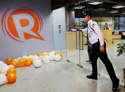 FILE PHOTO: A guard opens a door at the office of Rappler in Pasig, Metro Manila, Philippines January 15, 2018.   REUTERS/Dondi Tawatao/File Photo