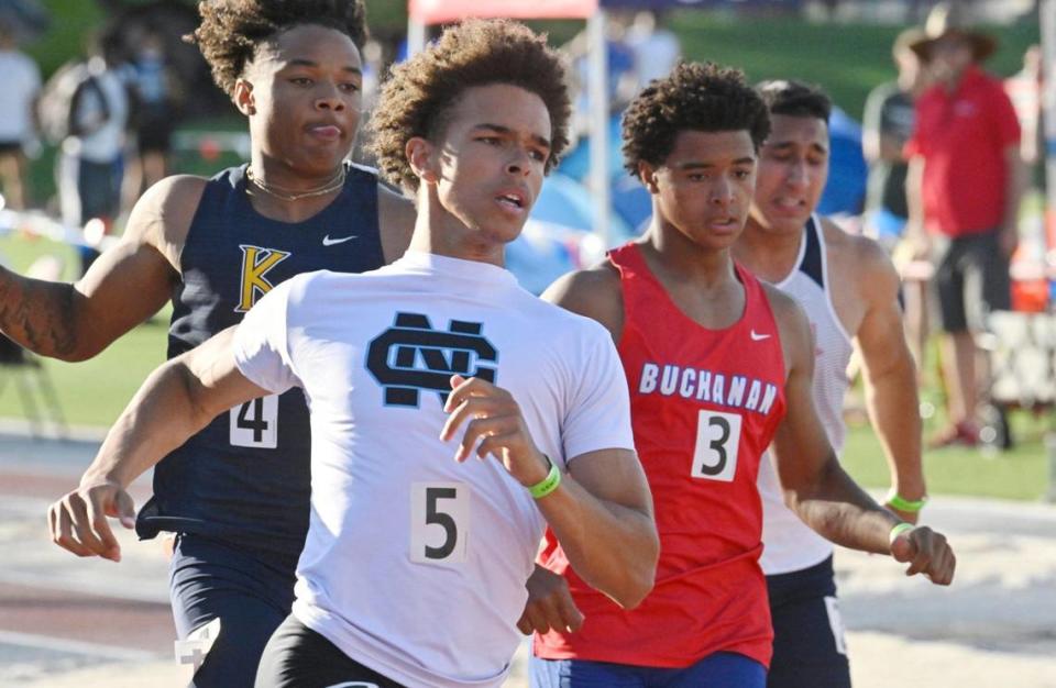 Clovis North’s Nickolas Miller, center, places first in the boys 100 at the 2023 CIF Central Section Masters track and field, held at Veterans Memorial Stadium on Saturday, May 20, 2023 in Clovis.