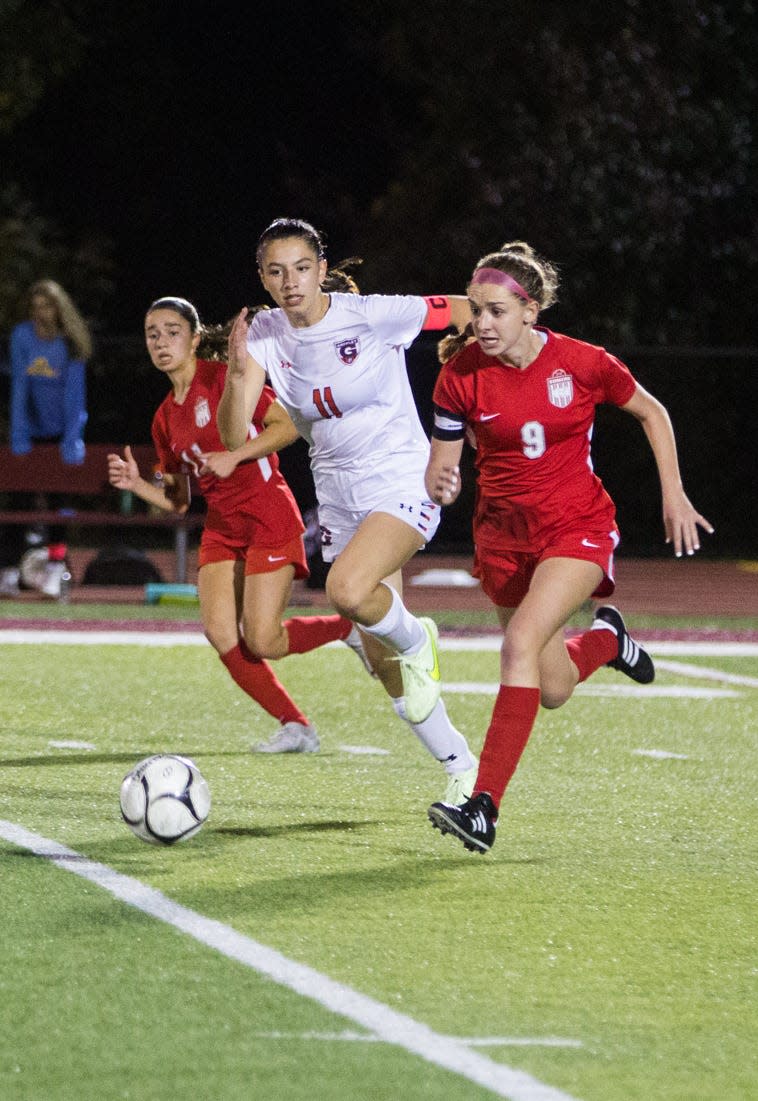 Somers' Annie Maguire (red) and Horace Greeley's Sophia Ivanov (white) run after the ball during the Section 1 Class AA finals at Nyack High School on Oct. 28, 2023.