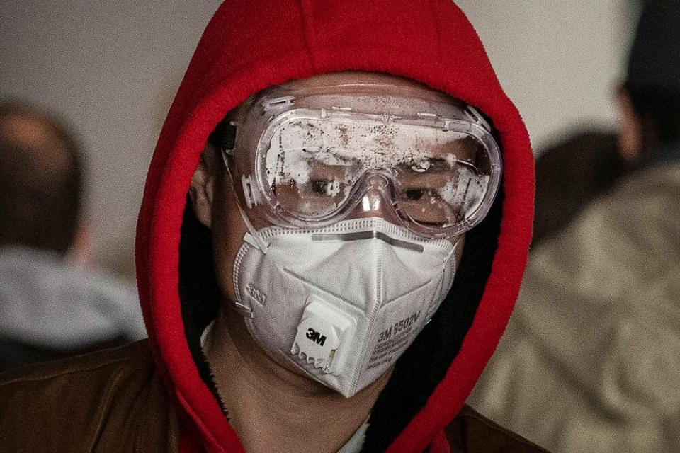 A man in Bejing wears a protective mask and goggles as he lines up to check in to a flight at Beijing Capital Airport on January 30, 2020, amid the outbreak of the coronavirus | Kevin Frayer/Getty