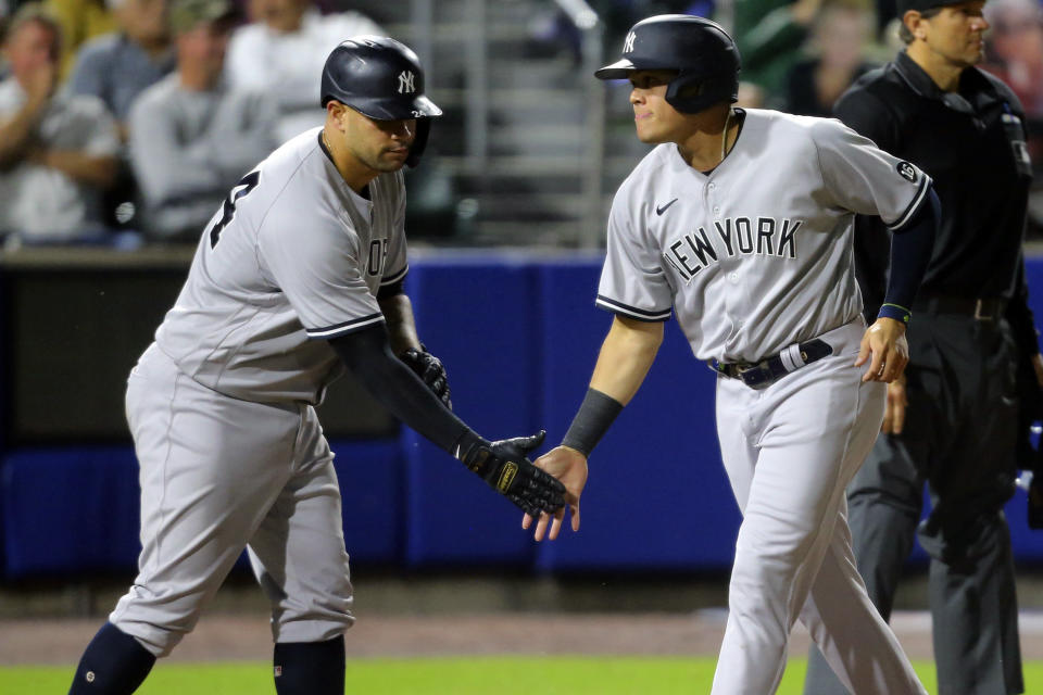 New York Yankees' Gary Sanchez, left, and Gio Urshela score on a single hit by Chris Gittens during the seventh inning of a baseball game against the Toronto Blue Jays, Thursday, June 17, 2021, in Buffalo, N.Y. (AP Photo/Jeffrey T. Barnes)