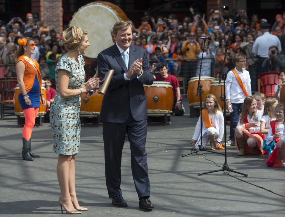 Netherlands' King Willem Alexander, right, and Queen Maxima, left, listen to singing children during festivities marking King's Day in Amstelveen, near Amsterdam, Netherlands, Saturday, April 26, 2014. The Dutch celebrate the first ever King's Day, a national holiday held in honor of the newly installed monarch, King Willem Alexander. King's Day replaces the traditional Queen's Day. (AP Photo/Patrick Post)