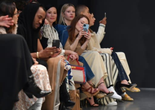 Lucy Liu (L) and Julianne Moore attend the Tory Burch fashion show during New York Fashion Week: The Shows at Sotheby's on February 9, 2020 in New York City