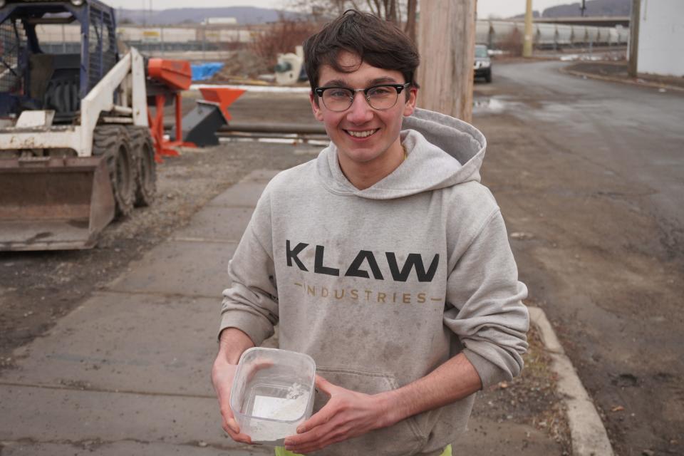 Jacob Kumpon with the finished product KLAW creates to replace some of the cement in concrete production.