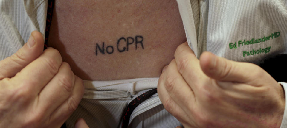 In this photo taken Sept. 29, 2011, Kansas City, Mo. pathologist Dr. Ed Friedlander displays his tattoo with a medical directive to not use CPR. Friedlander is among a growing number of people who are getting tattoos that tell doctors and first responders about their medical concerns, from chronic conditions like diabetes and asthma to allergies and more. (AP Photo/Charlie Riedel)