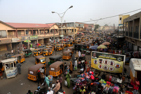 Taxis called in a local language Keke-Napep move in a street after the postponement of the presidential election in Kano, Nigeria February 17, 2019. REUTERS/Luc Gnago