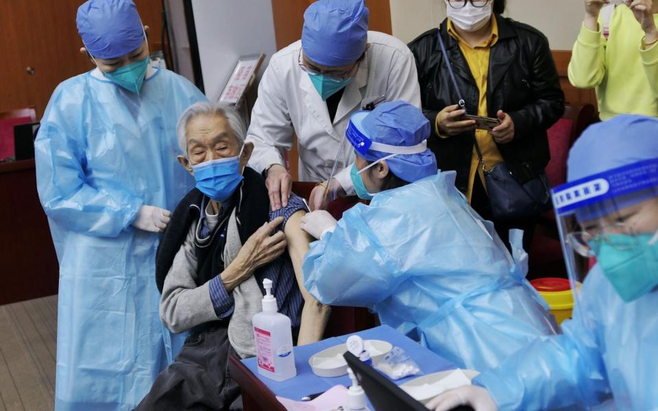 An elderly man receives Covid-19 vaccine at Chinese Academy of Social Sciences on April - Wei Tong/Beijing Youth Daily/VCG