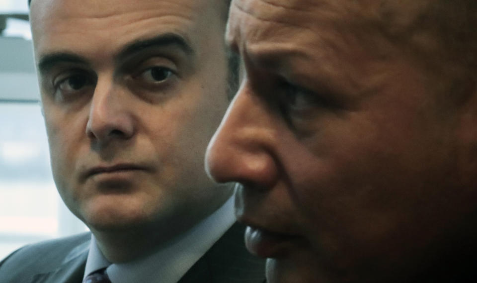 In this Tuesday, Oct. 29, 2019, photo, attorney Adam Slater, left, listens during an interview as his client Ramon Mercado, right, recalls childhood clergy sexual abuse, in New York. Slater's firm has seen a new wave of clients accusing the Roman Catholic Church of sexual abuse, after New York state opened its one-year window allowing sex abuse suits with no statute of limitations. (AP Photo/Bebeto Matthews)