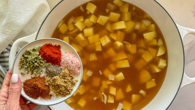 adding spices to pot