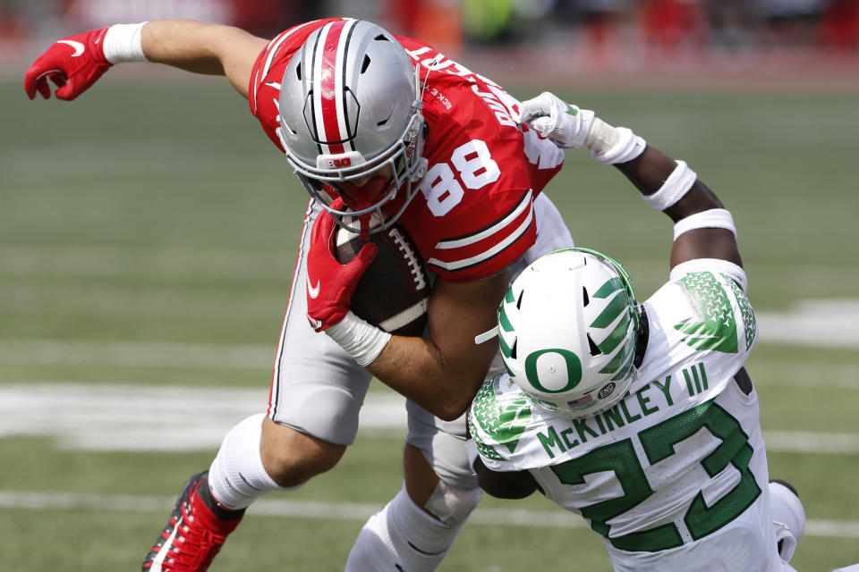 Oregon defensive back Verone McKinley, right, tackles Ohio State tight end Jeremy Ruckert during the second half of an NCAA college football game Saturday, Sept. 11, 2021, in Columbus, Ohio. Oregon beat Ohio State 35-28. (AP Photo/Jay LaPrete)