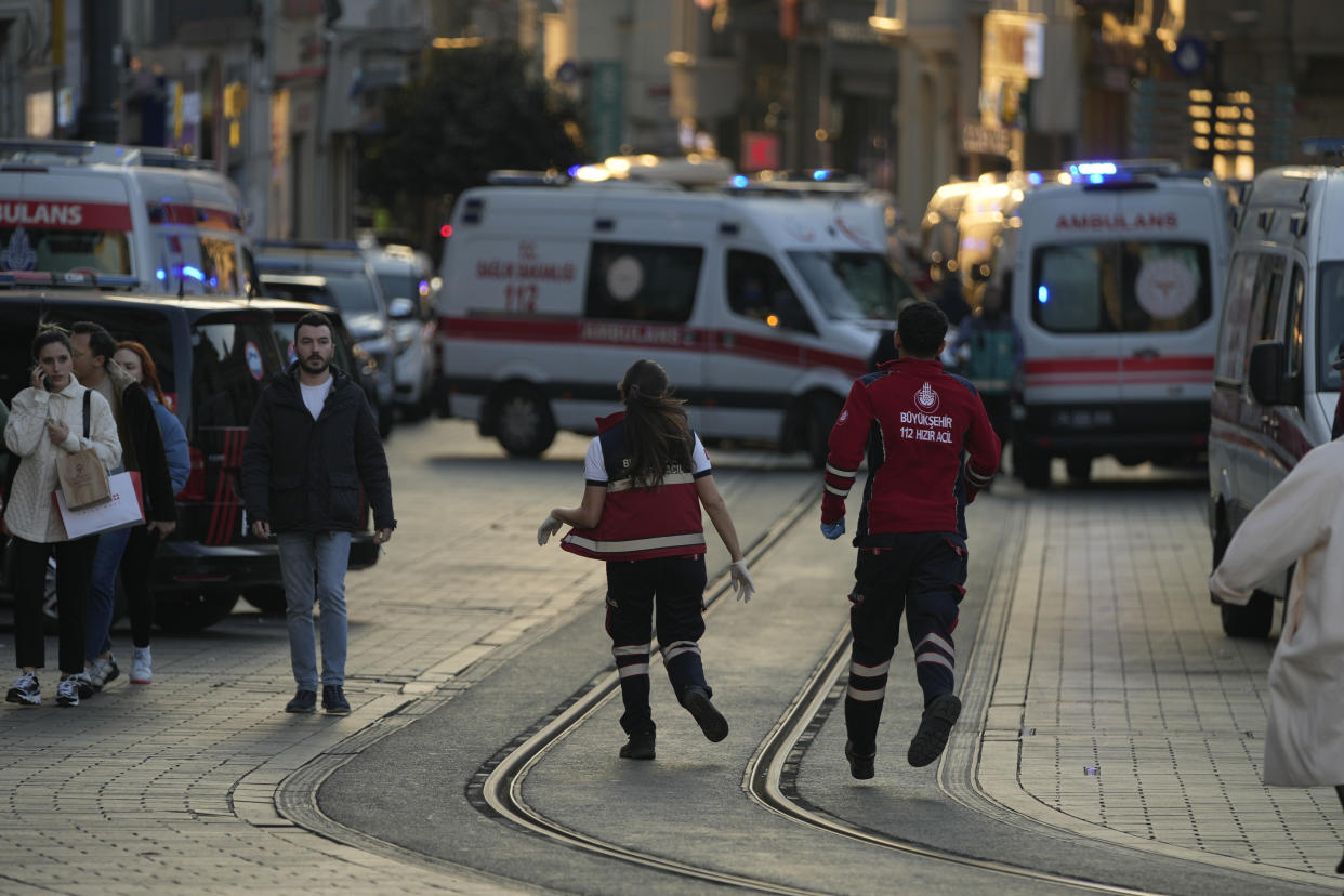 Security and ambulances at the scene after an explosion on Istanbul's popular pedestrian Istiklal Avenue, Sunday, Nov. 13, 2022. Istanbul Gov. Ali Yerlikaya tweeted that the explosion occurred at about 4:20 p.m. (1320 GMT) and that there were deaths and injuries, but he did not say how many. The cause of the explosion was not clear. (AP Photo/Francisco Seco)