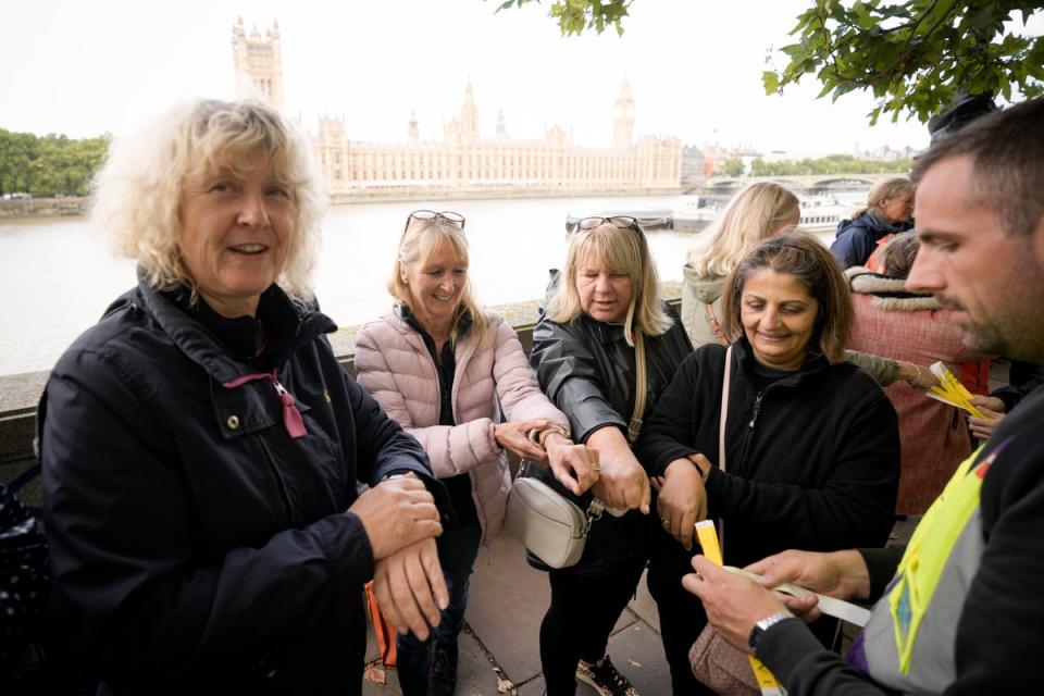 People wait for their wristbands to view Queen Elizabeth II lying in state ahead of her funeral in London, Wednesday, Sept. 14, 2022. (AP)