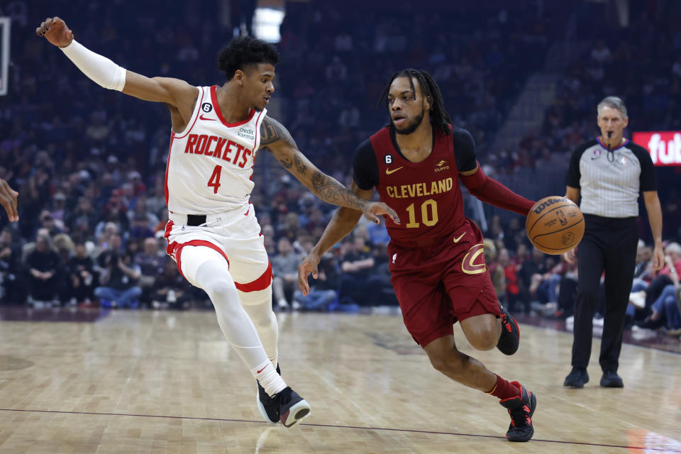 Cleveland Cavaliers guard Darius Garland (10) drives against Houston Rockets guard Jalen Green (4) during the first half of an NBA basketball game, Sunday, March 26, 2023, in Cleveland. (AP Photo/Ron Schwane)