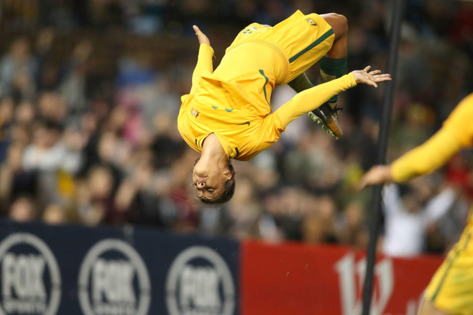 Australia soccer player Sam Kerr doing a backflip in celebration. 