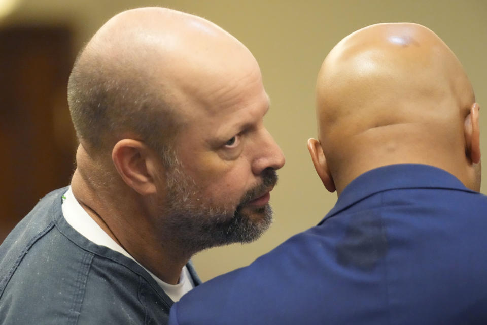 Former Rankin County sheriff’s deputy Brett McAlpin talks with his attorney at the Rankin County Circuit Court in Brandon, Miss., Monday, Aug. 14, 2023. McAlpin is one of six white former Mississippi law officers that pleaded guilty to state charges on Monday for torturing two Black men in a racist assault. All six had recently admitted their guilt in a connected federal civil rights case. (AP Photo/Rogelio V. Solis)