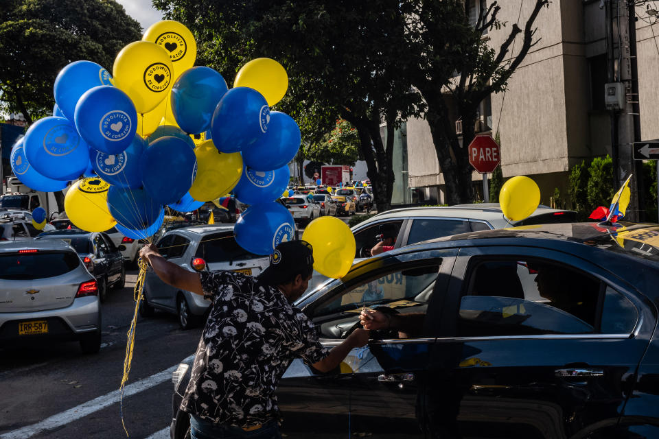 Un vendedor ambulante ofrece globos con mensajes de apoyo a Hernández en Bucaramanga. (Federico Rios/The New York Times)
