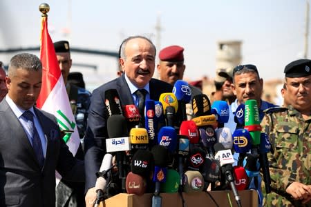 Syrian Interior Minister Mohammad Khaled al-Rahmoun speaks during the reopening of the Iraqi-Syrian border crossing, in Al Qaim