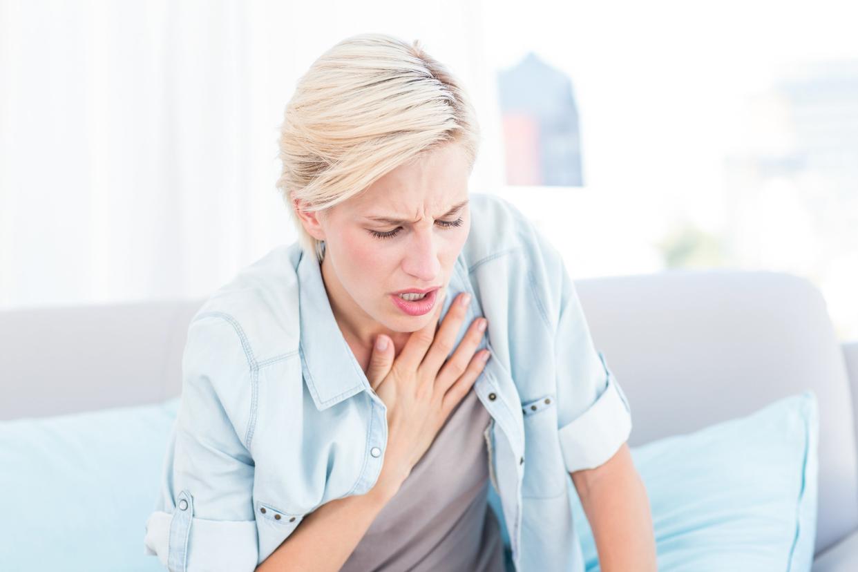 woman having breath difficulties in the living room