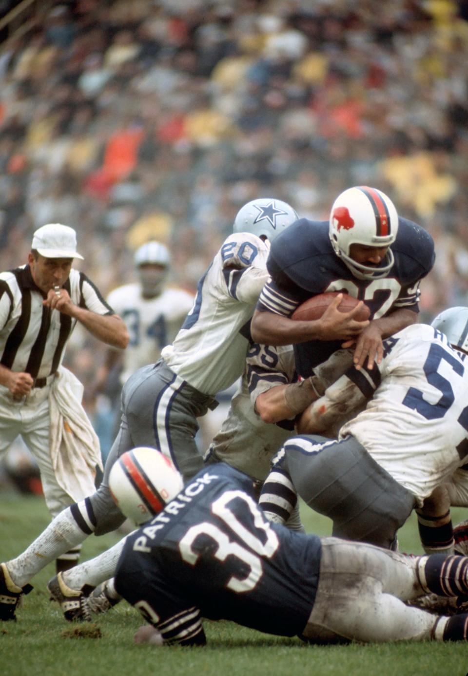 Buffalo Bills running back O.J. Simpson lunges over the pile against the Dallas Cowboys in a 1971 game. Simpson was one of the all-time greats on the field.