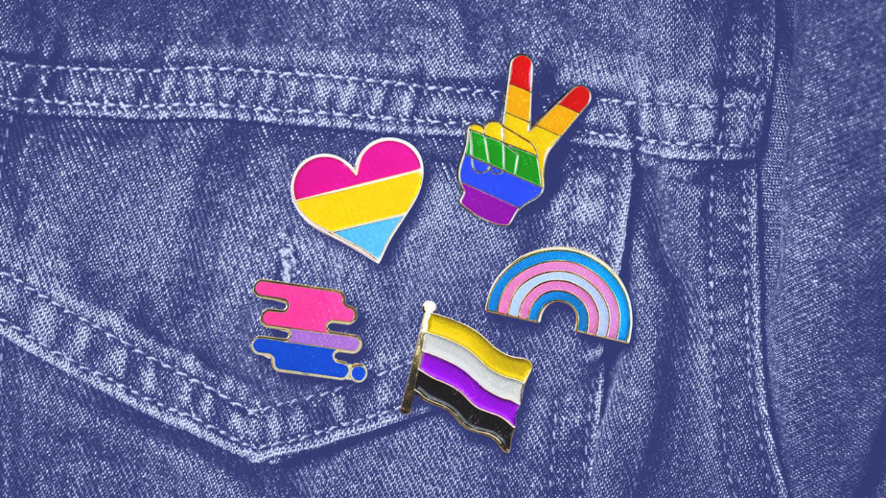 Pocket of denim jacket with five pride and rainbow pins