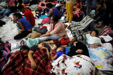 Honduran migrants, part of a caravan trying to reach the U.S., rest inside a improvised shelter during a new leg of their travel in Chiquimula, Guatemala October 16, 2018. REUTERS/Edgard Garrido