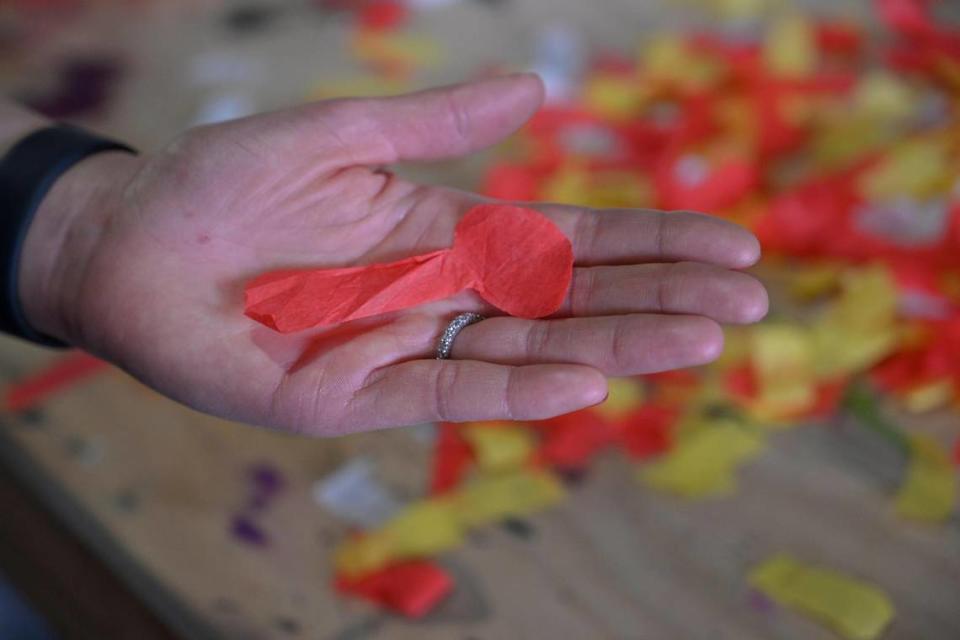 Kansas City-based artist Megh Knappenberger displays a piece of confetti shaped like the Lombardi Trophy that was collected from the field after the Chiefs’ Super Bowl Championship in 2023 in Phoenix, Arizona. Knappenberger is using the confetti to create a limited edition of 222 LVII Confetti Shadow boxes.