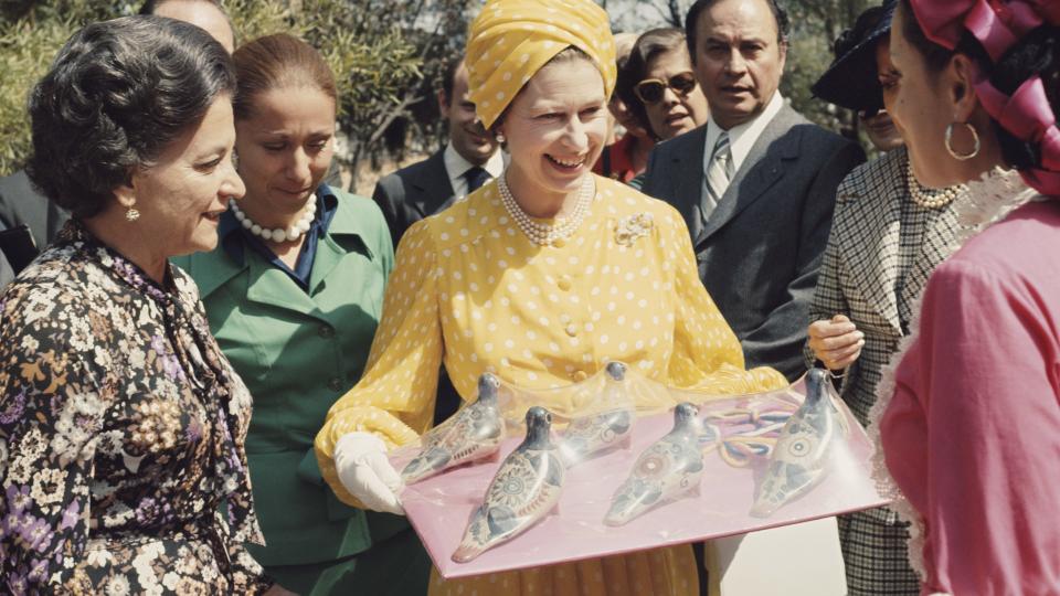 Queen Elizabeth II receives some local crafts during her state visit to Mexico, 1975.