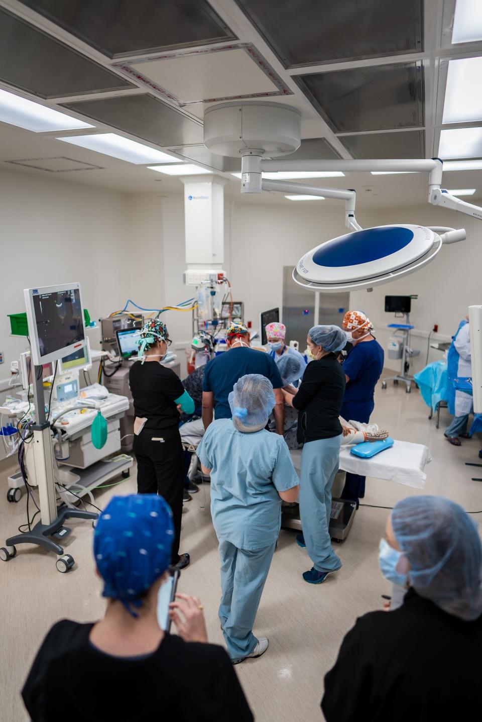 In the operating room at Dell Children's Medical Center, Dr. Kenneth Moise Jr., Dr. Michael Bebbington and surrounding staffers work on Jeannette Becerra's babies, the first fetal surgery at Dell Children's.