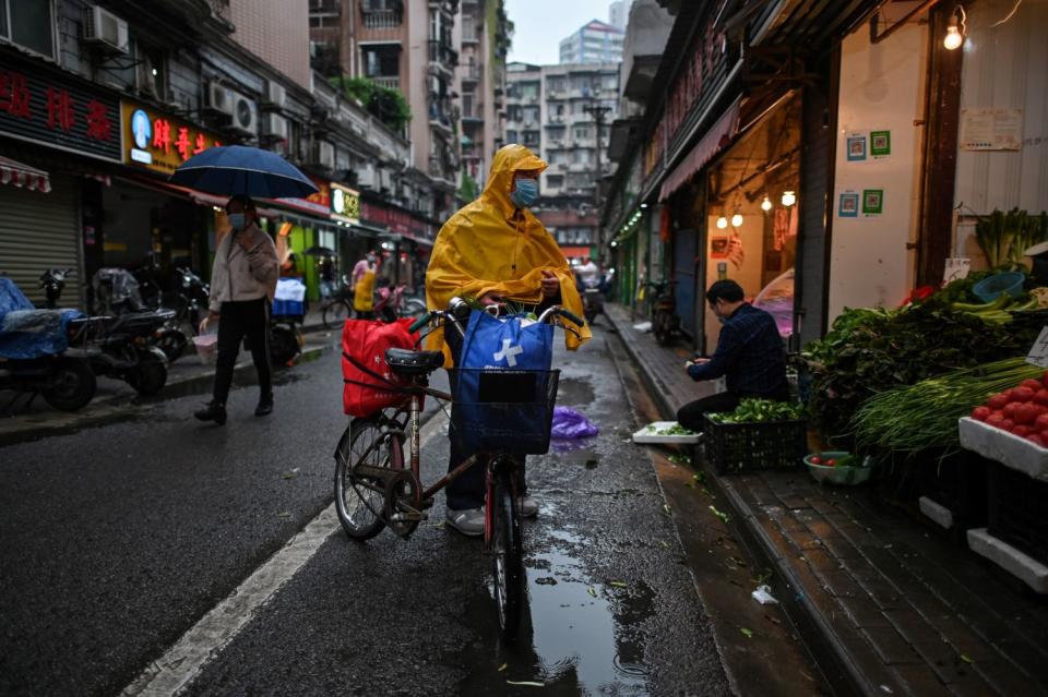 A man buys vegetables at a stall in Wuhan, China, on April 18, 2020.