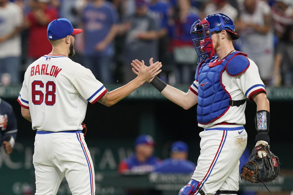 Texas Rangers catcher Sam Huff, right, congratulates closer Joe Barlow (68) after the team's baseball game against the Atlanta Braves in Arlington, Texas, Saturday, April 30, 2022. The Rangers won 3-1. (AP Photo/LM Otero)