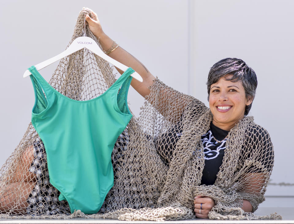 Marina Hamm, a designer and merchandiser for Volcom, displays one of the brand's bathing suits made from recycled fishing nets. (Photo: Digital First Media / Orange County Register via Getty Images)