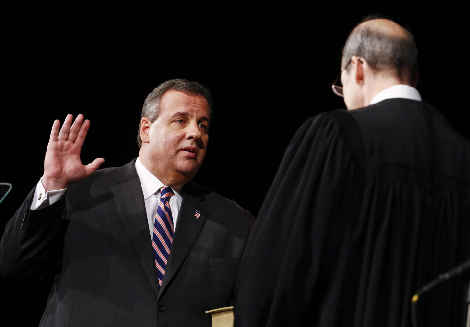 TRENTON, NJ - JANUARY 21: New Jersey Gov. Chris Christie (L) is sworn in by Chief Justice of the New Jersey Supreme Court Stuart Rabner for his second term on January 21, 2014 at the War Memorial in Trenton, New Jersey. Christie begins his second term amid controversy surrounding George Washington Bridge traffic and Hurricane Sandy relief distribution.  (Photo by Jeff Zelevansky/Getty Images)