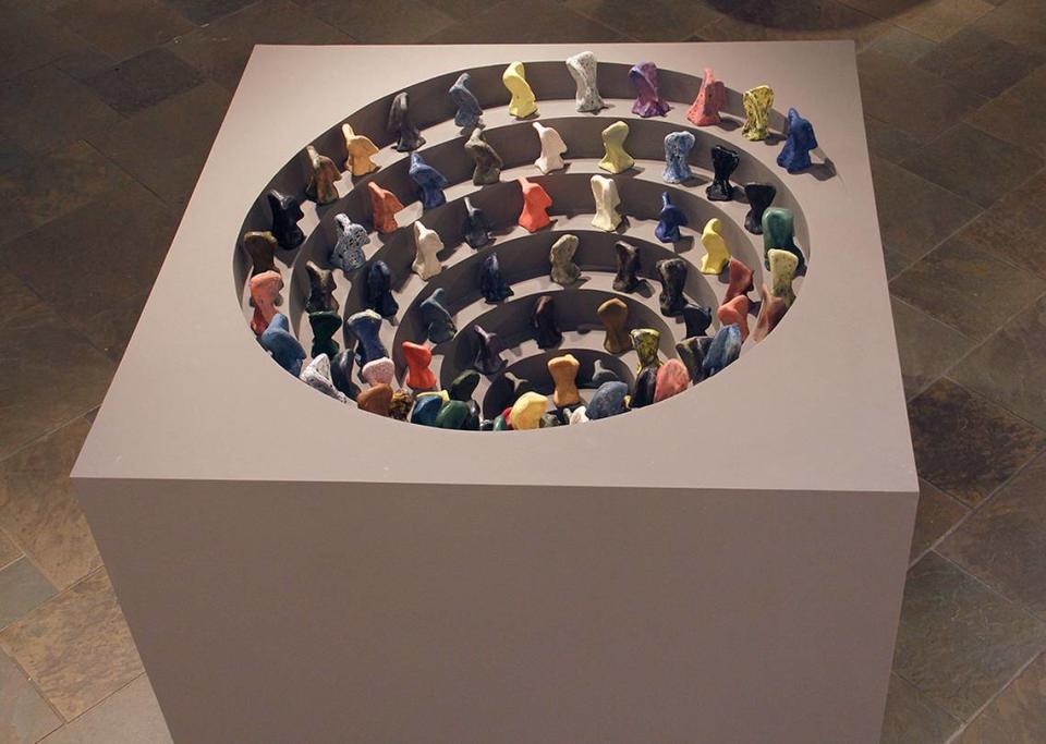 This work by Keith Bryant is called “Void.” The ceramic figurines are marching in a spiral toward whatever comes after life. “You’re supposed to kind of be looking into the abyss and going around and around in circles,” said CPCC gallery coordinator Amelia Zytka, “or you could read it the other way: you’re coming up out of something.”