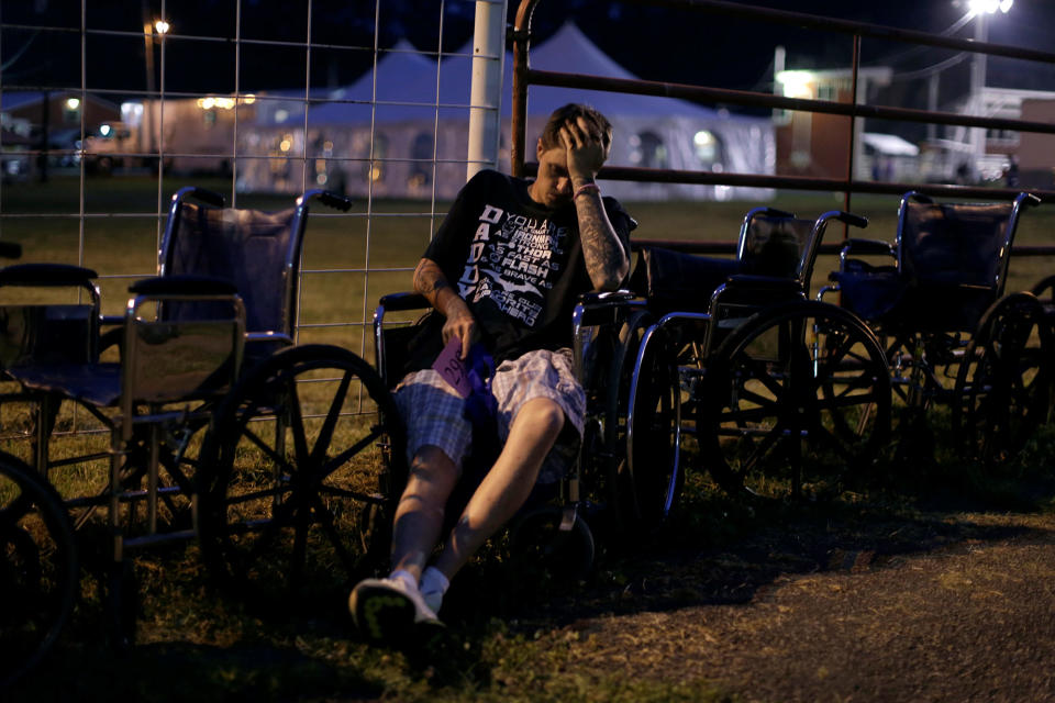 Josh Phillips waits in a wheel chair