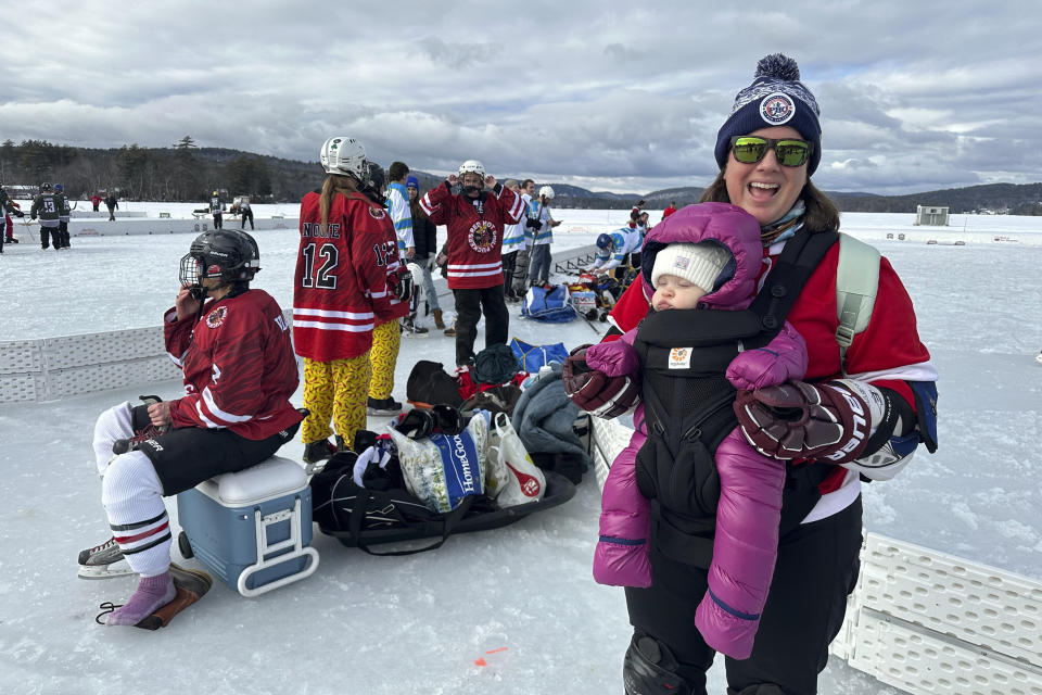 Hockey players assemble for a game in Meredith, N.H., Friday, Feb. 2, 2024. Like many winter traditions on lakes across the U.S., pond hockey is under threat from climate change. (AP Photo/Nick Perry)