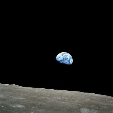The distant blue Earth is seen above the Moon's limb, in this handout picture taken by the Apollo 8 crew forty-five years ago, on December 24, 1968, courtesy of NASA. REUTERS/NASA/Handout via Reuters