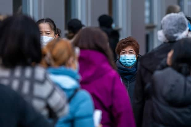 People wait in line for their COVID-19 vaccine in Vancouver on Dec. 22, 2020. (Ben Nelms/CBC - image credit)