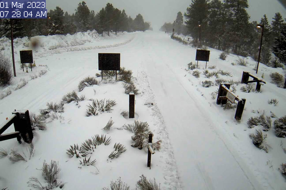 In this photo provided by the National Park Service is a webcam view of the snow-covered entrance station to the Grand Canyon National Park's South Rim in Arizona, on Wednesday, March 1, 2023. (National Park Service via AP)
