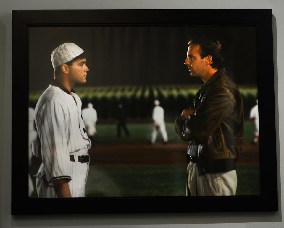 Ray Liotta, known for his role as Shoeless Joe Jackson, left, stands with Kevin Costner in the movie “Field of Dreams,” in this photo featured on a wall at the Shoeless Joe Jackson museum in Greenville, S.C.