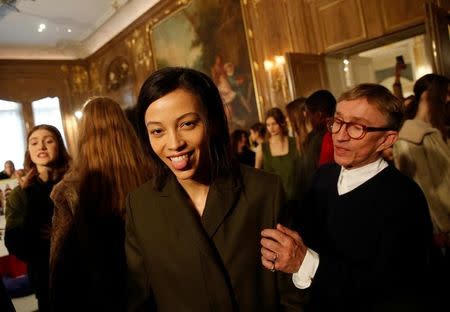 A model is groomed by designer Jasper Conran (R) before his catwalk show during London Fashion Week in London, Britain February 18, 2017. REUTERS/Neil Hall